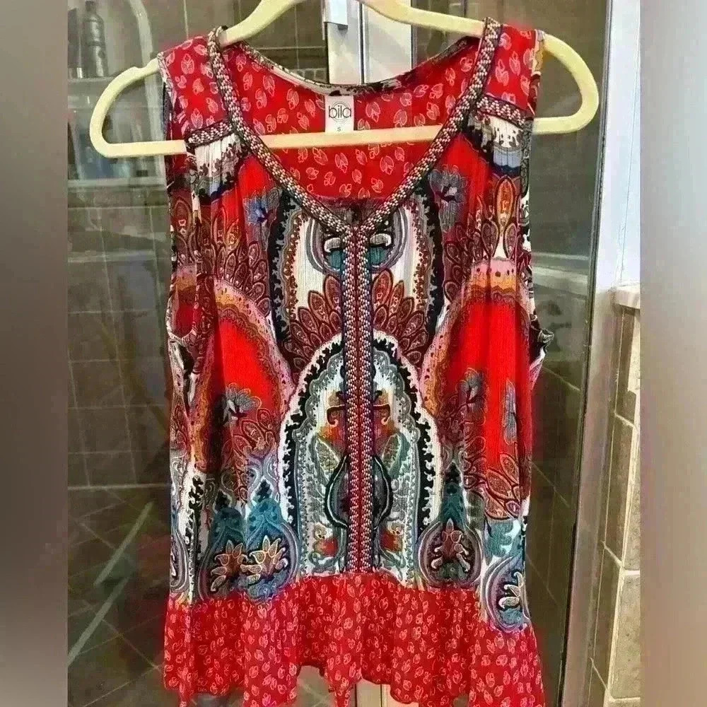 Bright and colorful summer sleeveless top with ruffle at bottom. Size S.